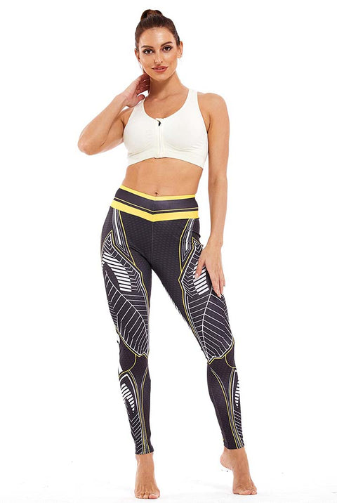 Sportlegging, yoga legging met abstract blad design in zwart, wit en gele kleurcombinatie